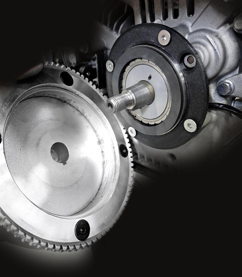 Steamer Power Dynamo 20 on a small engine, with the billet electric-start flywheel beside it